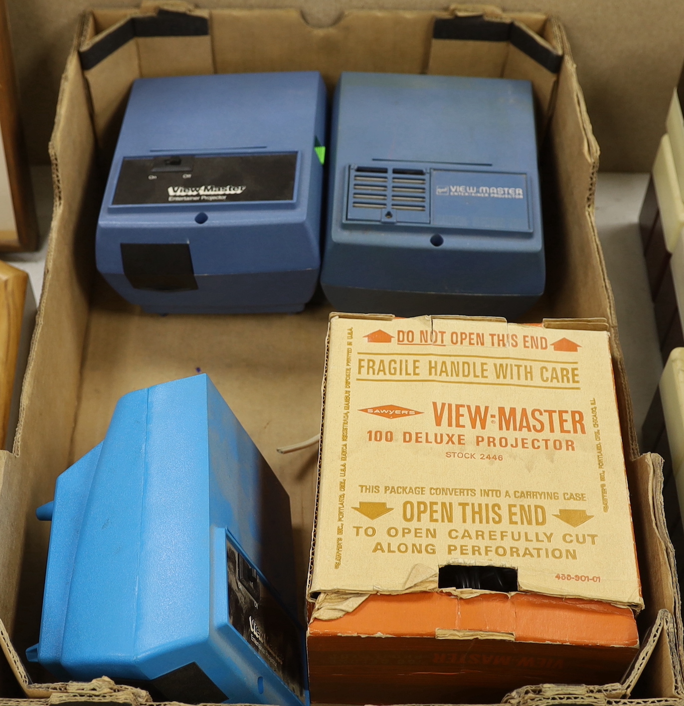 A View-Master metal Standard Projector and three Junior Projectors